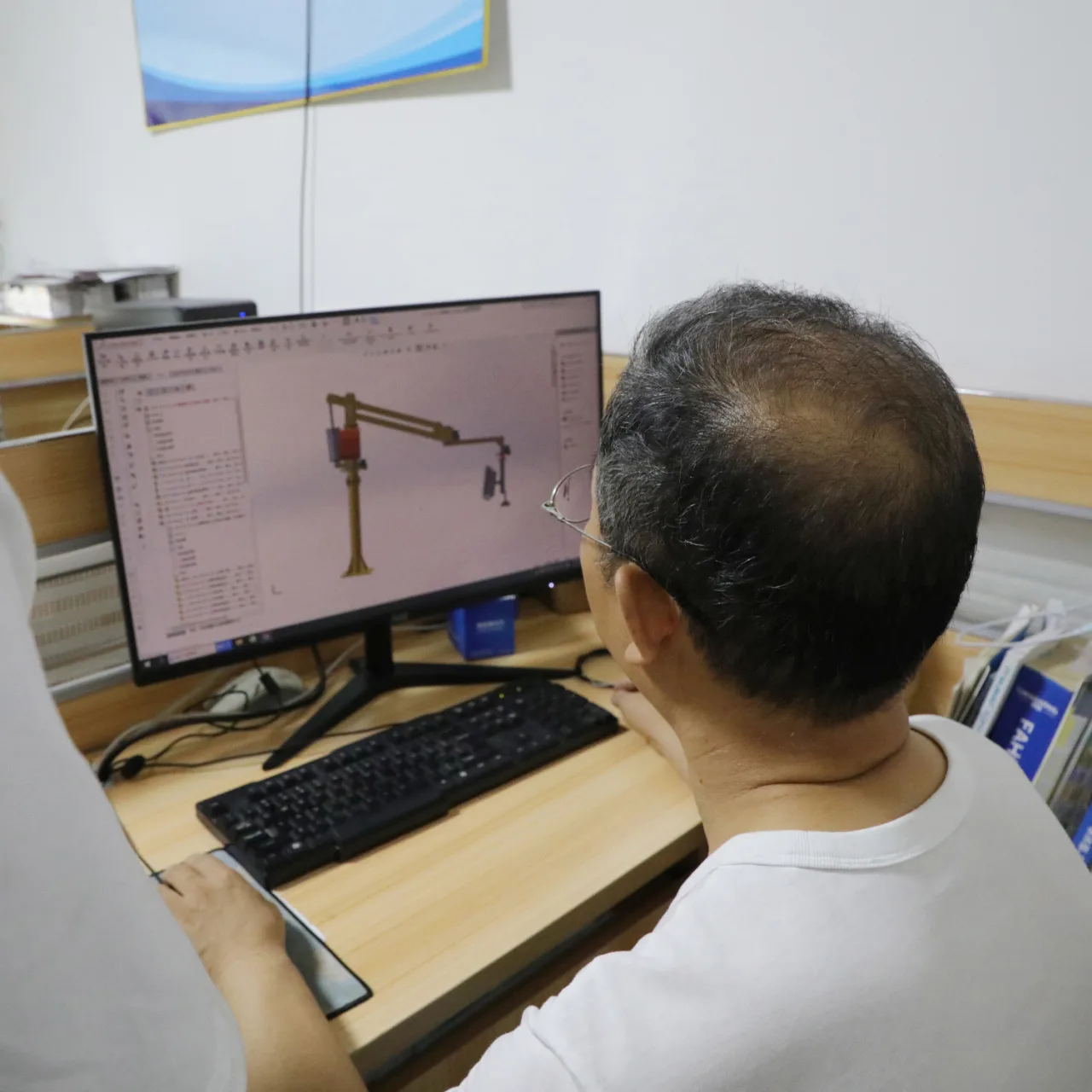 Layout work: reviewing a crane arrangement on screen. Project drawings are prepared around the agreed installation scope.