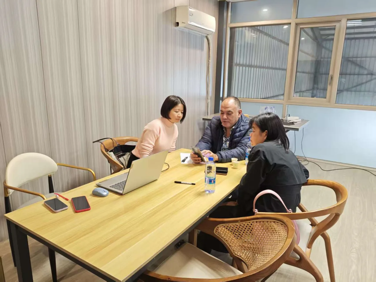 An equipment project discussion, reviewing requirements around the table.