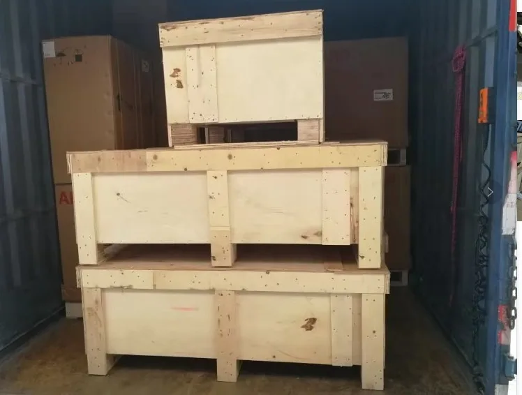 Packing example: crated equipment placed in a shipping container.